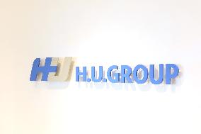 H.U. Group Holding Sign and Logo